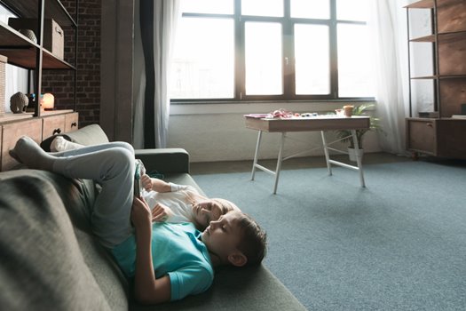 kids chilling couch with tablet