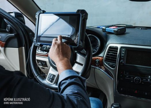 Car diagnostic. Technical inspection, car electronics. A Latin man holds a digitizing device.