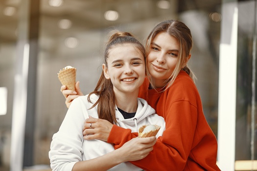 Portrait of beautiful women. Model in summer city. Girls with ice cream.