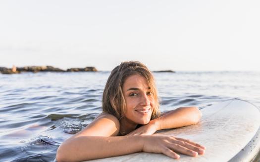 woman with surfboard water