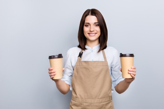 Part-time job person owner cacao routine lifestyle rest break relax leisure pause concept. Portrait of kind friendly pleasant girl giving two big latte isolated on gray background copy-space