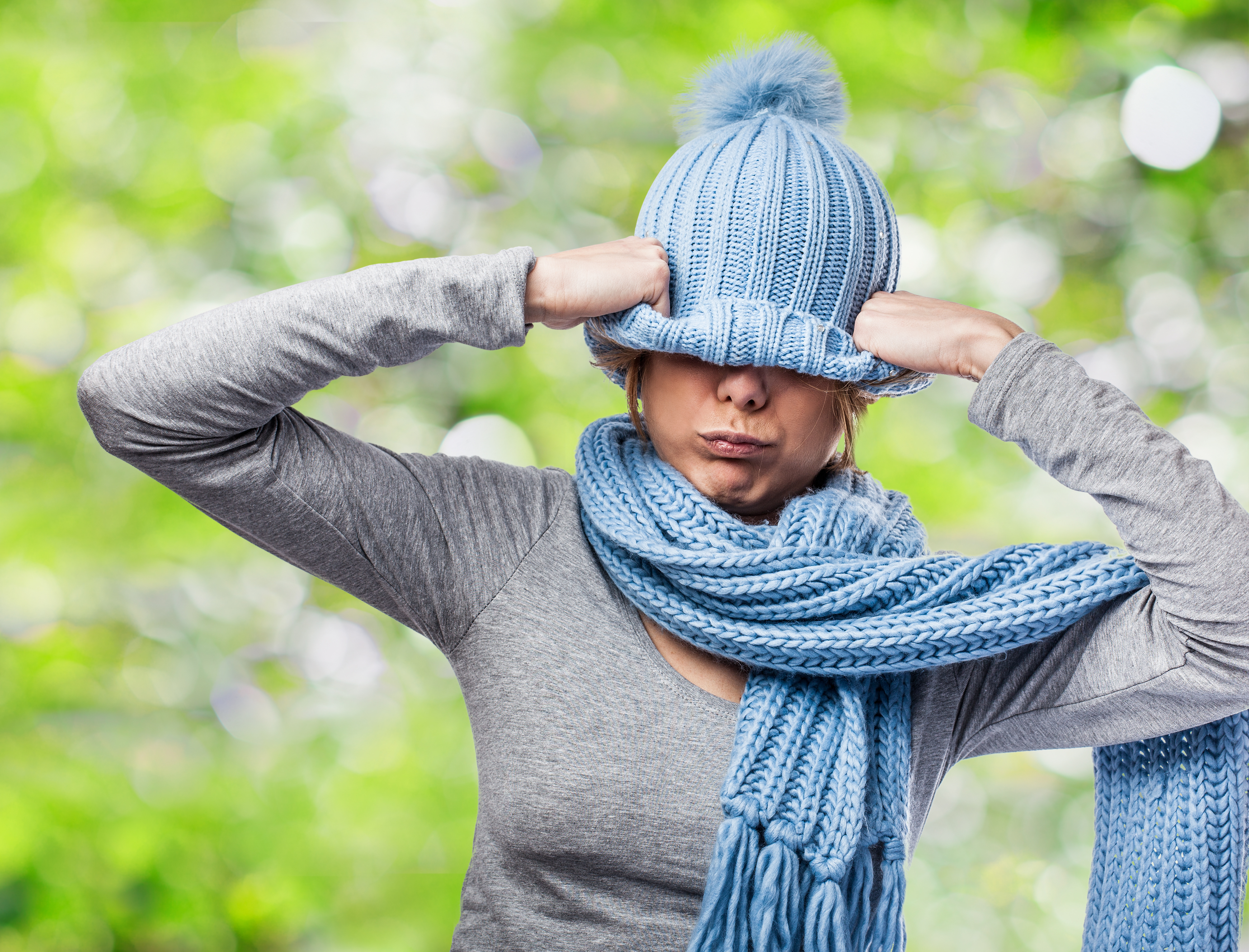 portrait of a pretty young woman covering her head with a wool cap