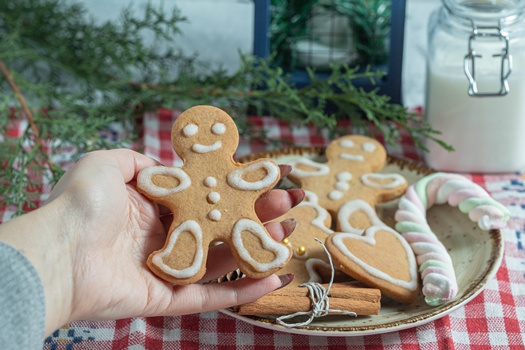 Close up photo of Female hand taking cookie from plate. High quality photo