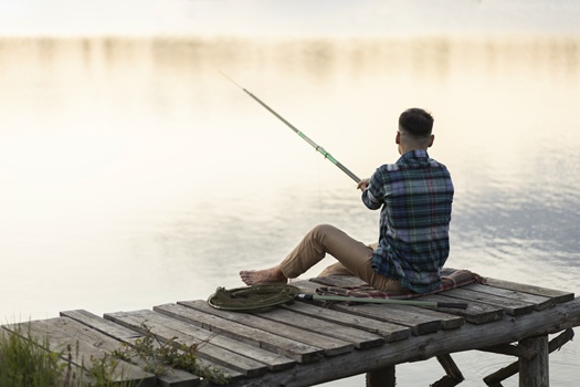 man fishing by himself full shot