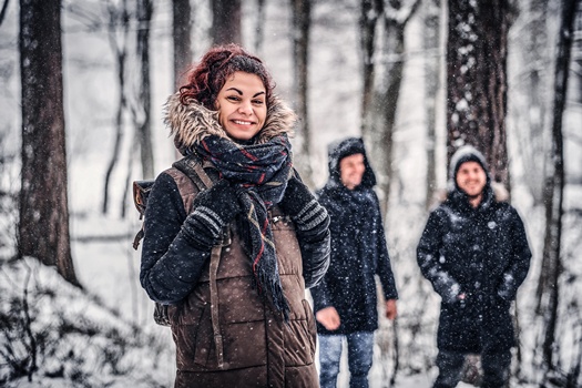 Red-haired student travels with friends in the Snowy forest