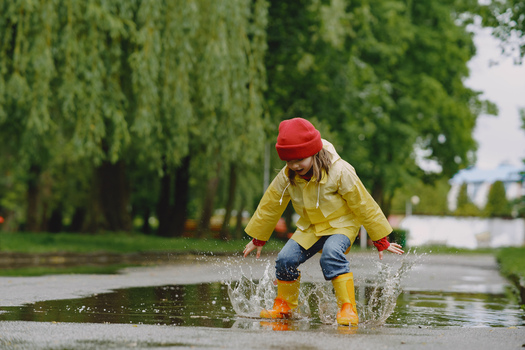 Kids in a puddle. Child having fun outdoors.