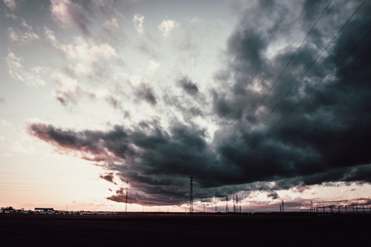 long shot dark cloudy sky antenna towers