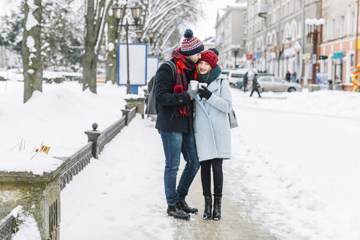 stylish couple with coffee winter city