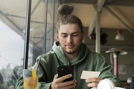 low angle man holding smartphone