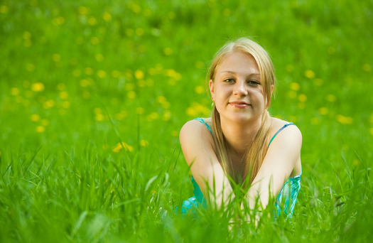 Pretty smiling  girl  relaxing outdoor in grass