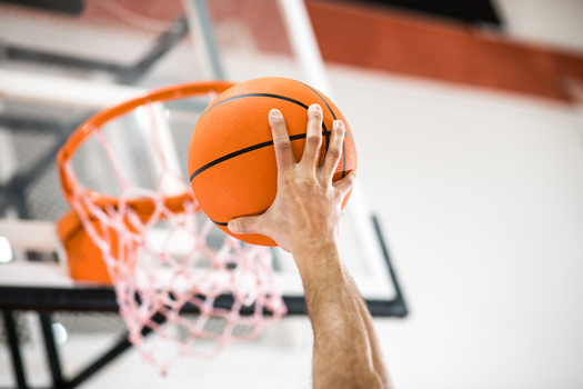 Basket-ball. Sportman throwing a ball into the basket