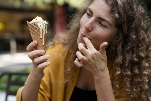 young woman eating ice cream cone