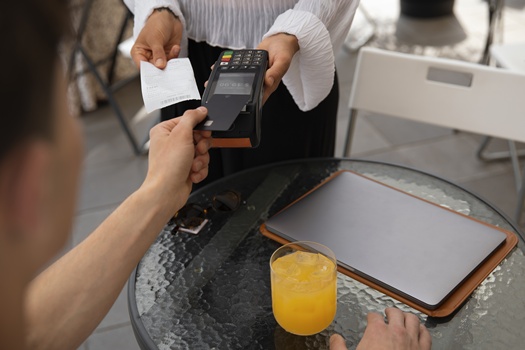 high angle customer paying with nfc device
