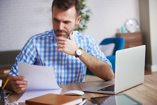 Business person reading important documents at his desk