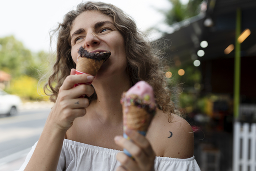 young woman eating ice cream cone